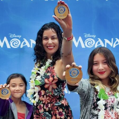 Casey and her daughters attend an advanced screening of Disney's live action Moana (2026) in San Francisco. They are holding keychains in the shape of the heart of Te Fiti