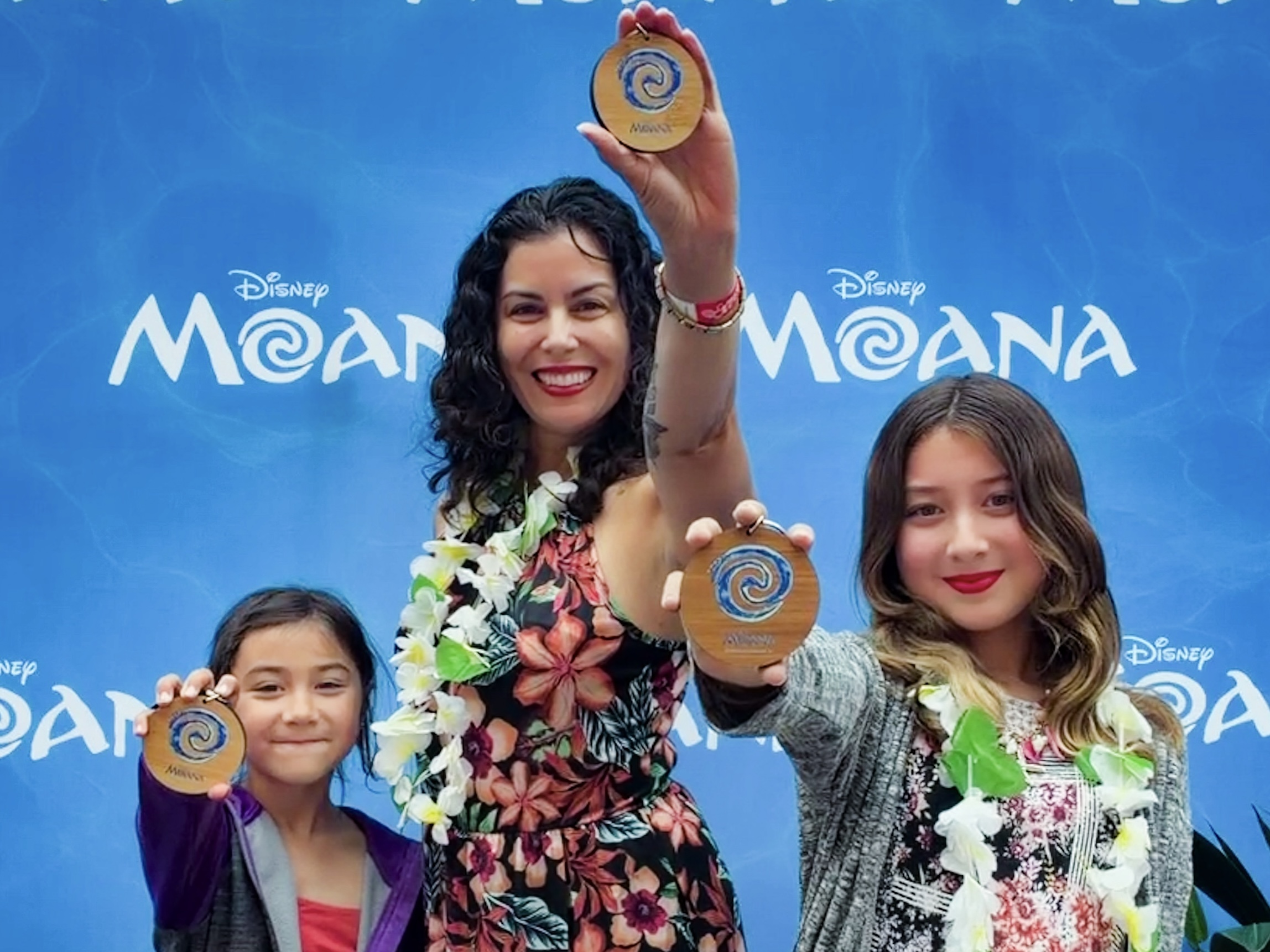 Casey and her daughters attend an advanced screening of Disney's live action Moana (2026) in San Francisco. They are holding keychains in the shape of the heart of Te Fiti